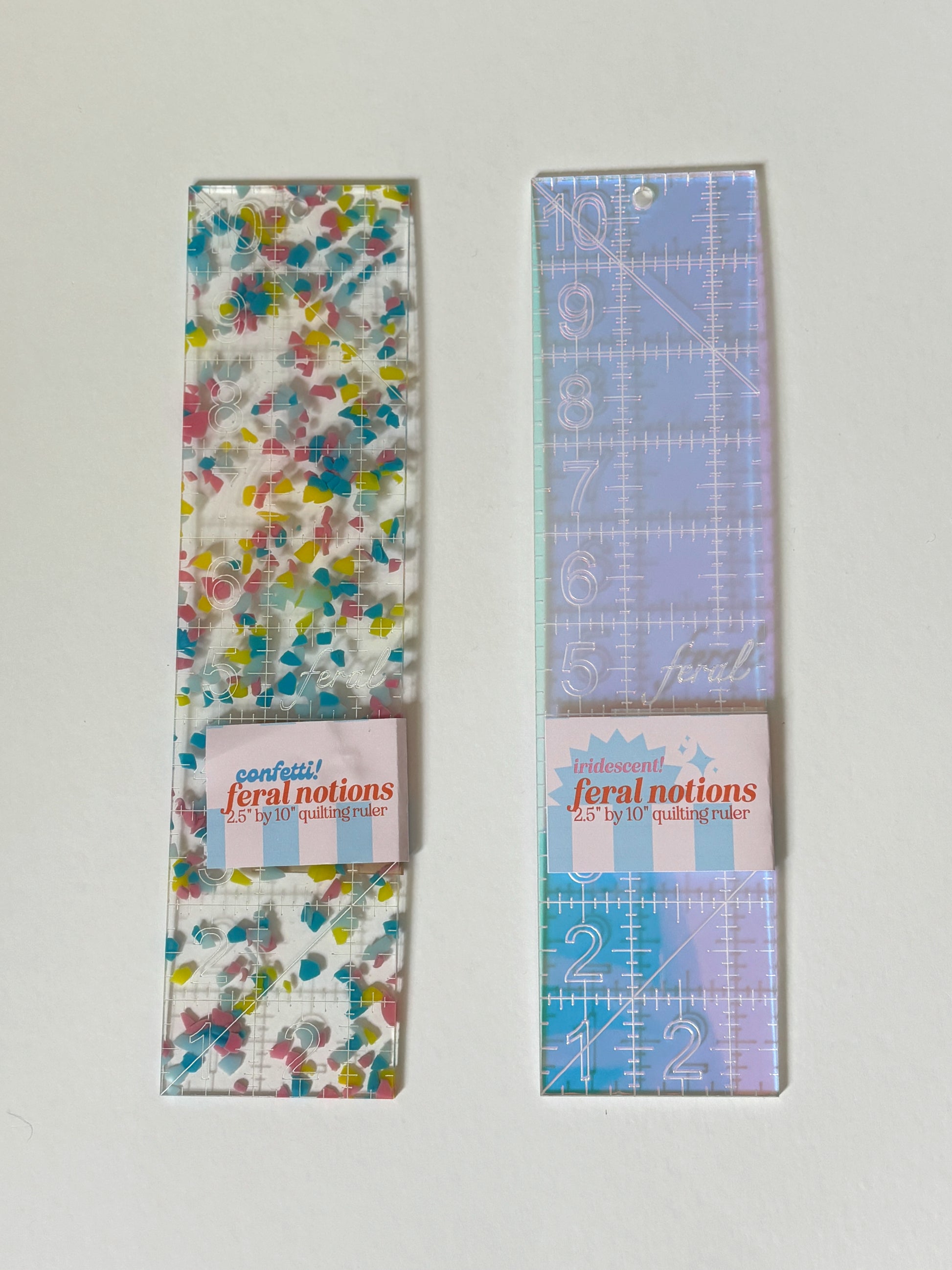 2.5 x 10 inch acrylic ruler by Feral Notions for needlepoint finishing, shown in Confetti colorway, ideal for cutting batting, tracing matboard, and measuring backing fabric