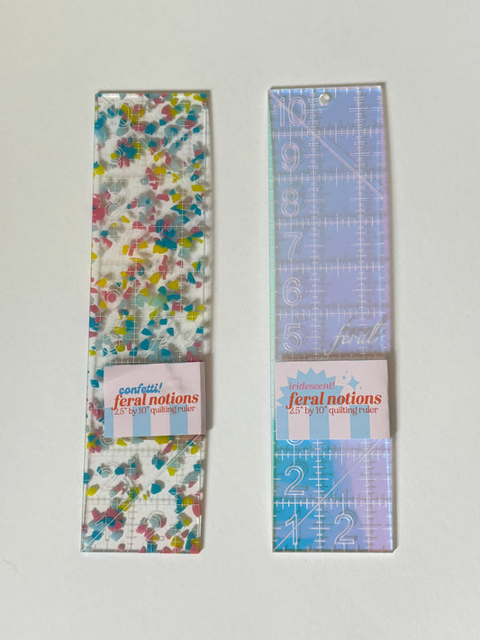 2.5 x 10 inch acrylic ruler by Feral Notions for needlepoint finishing, shown in Confetti colorway, ideal for cutting batting, tracing matboard, and measuring backing fabric