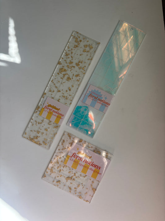 Feral Notions 2.5 x 10 inch ruler shown in available colorways for needlepoint finishing projects, curated by the Needlepoint Finishing Fairy