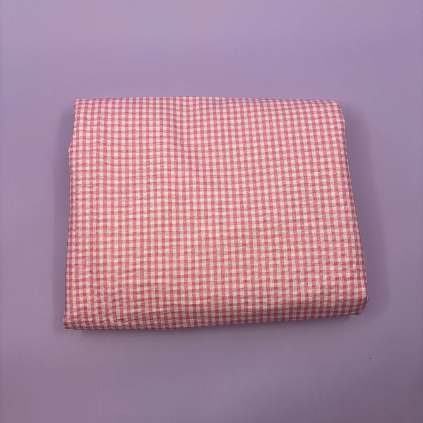 Gingham fabric cut for needlepoint finishing, 12 x 38 inches, shown flat in a classic check pattern ideal for ornament and standup backing. Pink and white.