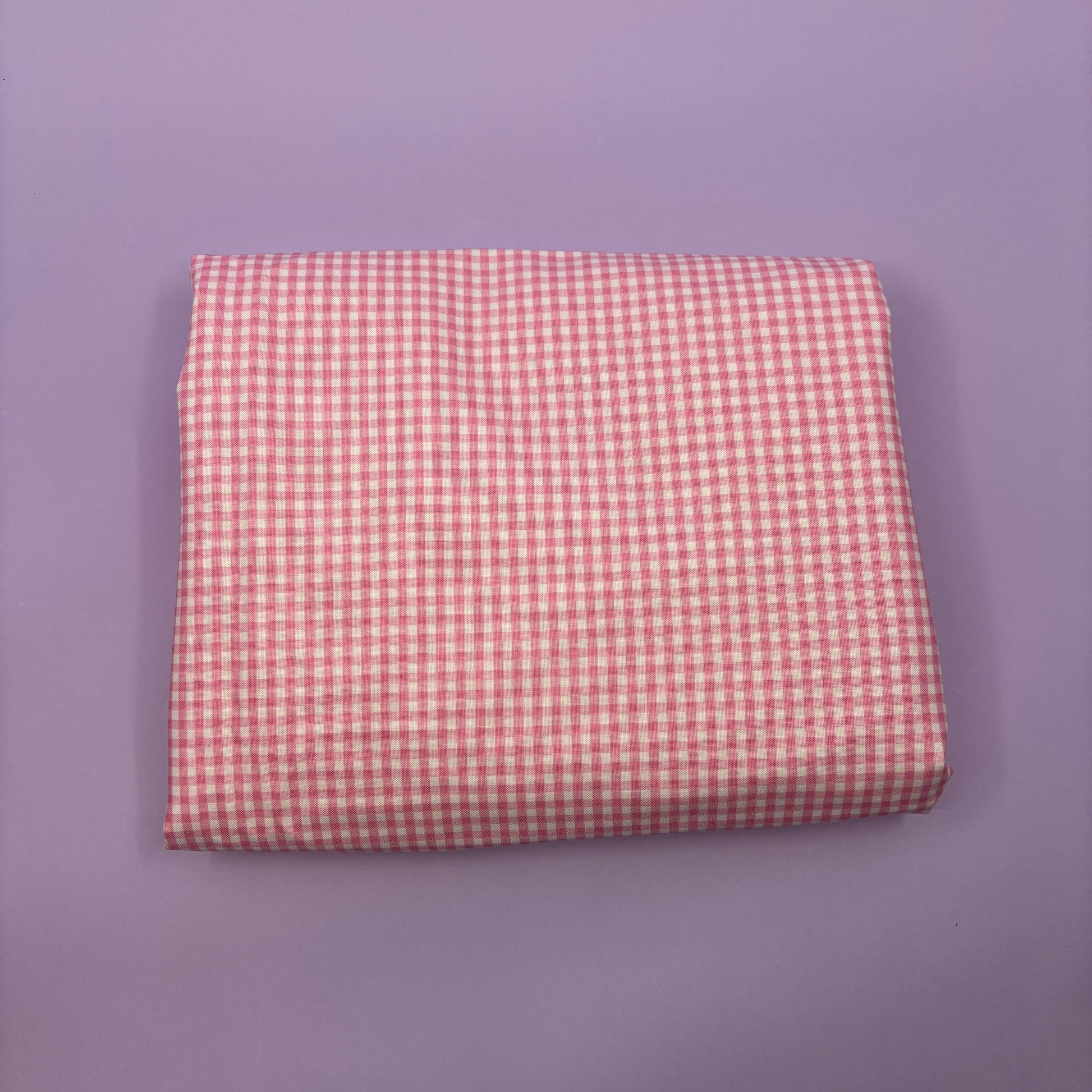 Gingham fabric cut for needlepoint finishing, 12 x 38 inches, shown flat in a classic check pattern ideal for ornament and standup backing. Pink and white.