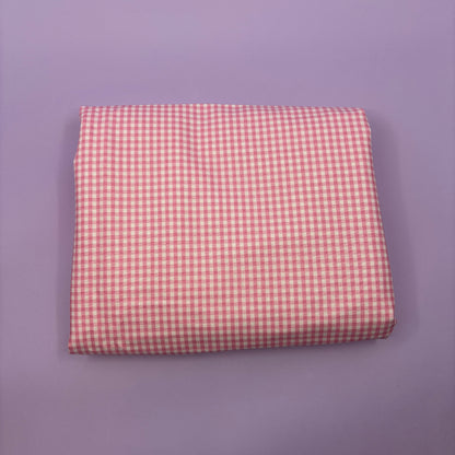 Gingham fabric cut for needlepoint finishing, 12 x 38 inches, shown flat in a classic check pattern ideal for ornament and standup backing. Pink and white.